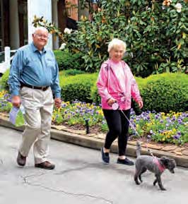 retired couple walking their dog