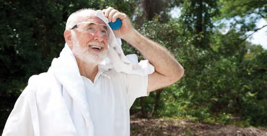 Retired man wiping the sweat off his head during a game of pickleball