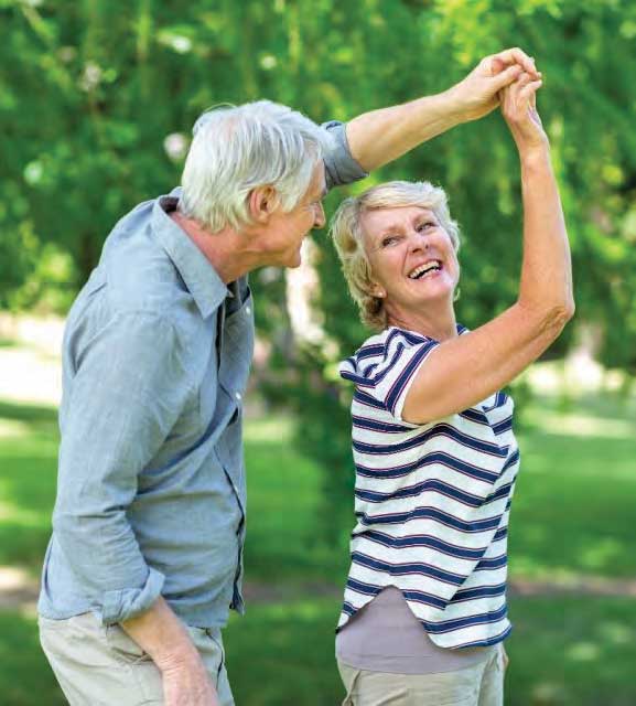 Retired couple dancing outside