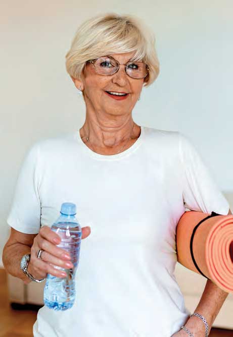 woman holding a yoga mat