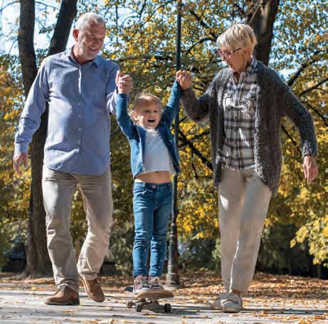 couple walking outdoors with their grandson