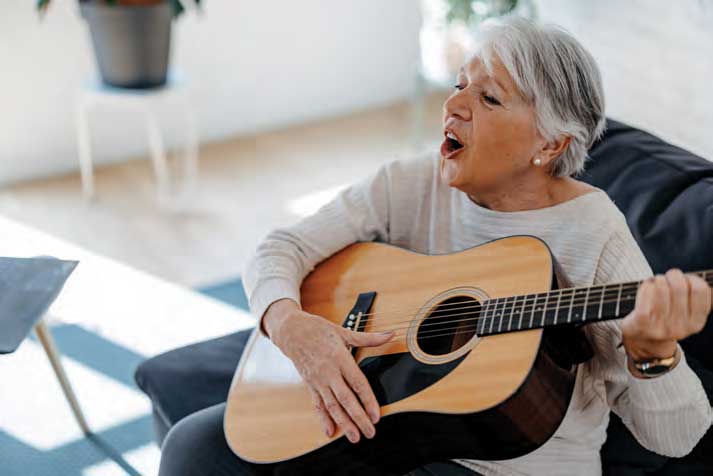 Woman singing and playing guitar