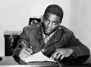 Jackie Robinson at a desk writing