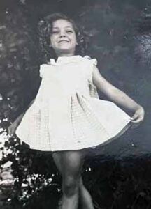 Jan posing for a photo at age 4