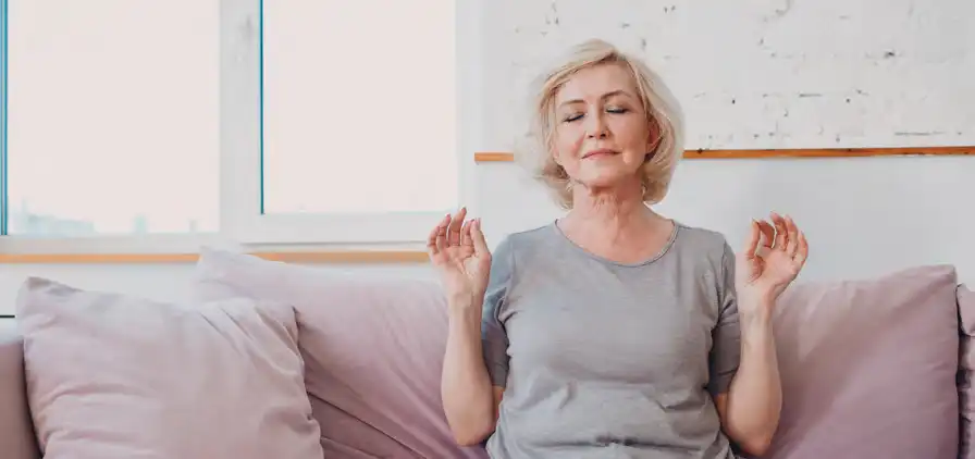 Woman practicing deep breathing on the couch