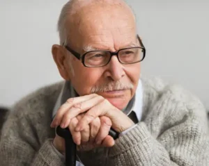 Man sitting with a cane