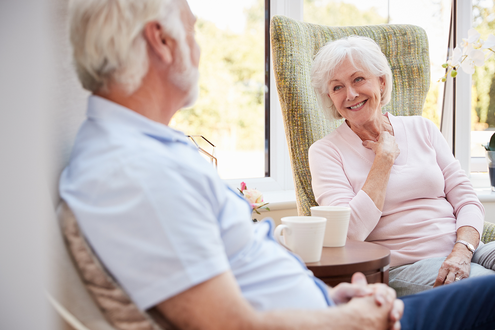 Senior couple sitting in chairs at an assisted living community in Memphis, TN