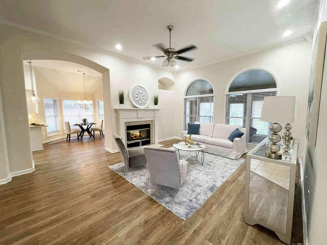 Living room photo with arched doorways and a sitting area