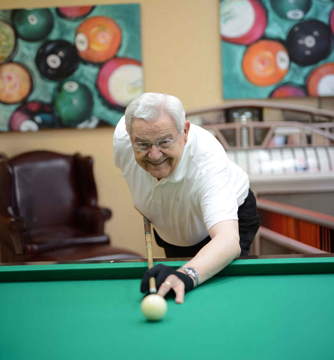 Man playing billiards in entertainment room