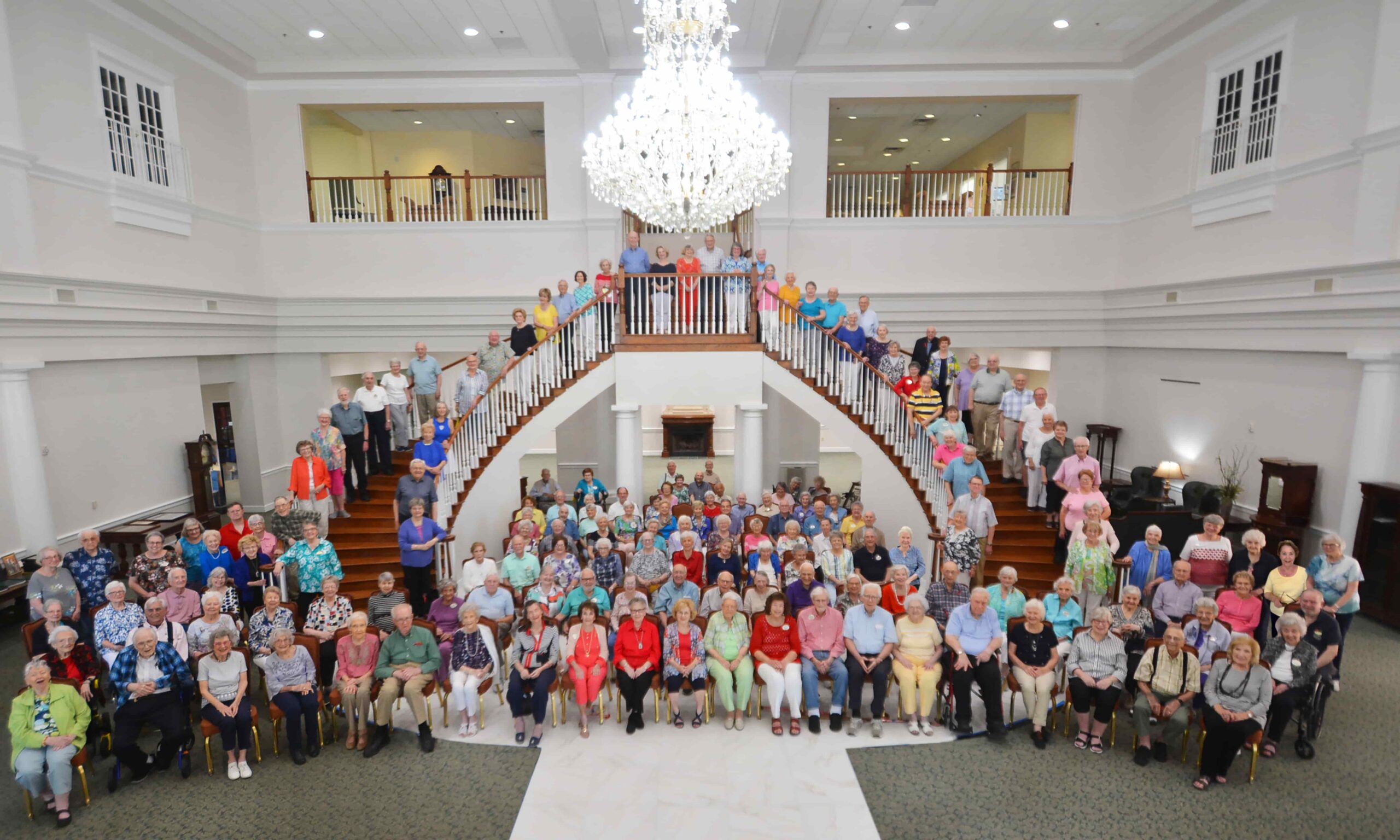 residents lining the curved stairways as a large group picture