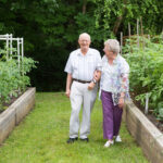 seniors walking thru garden