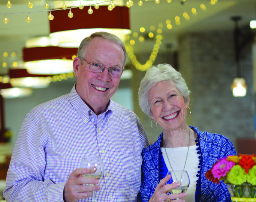 man and woman smiling at the camera