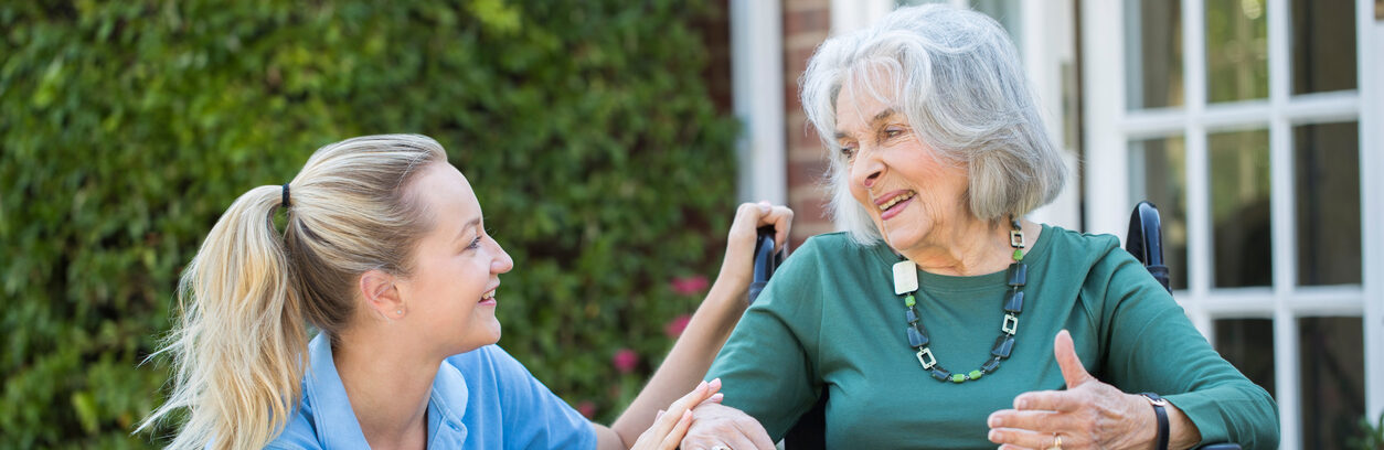 nurse outside with senior woman