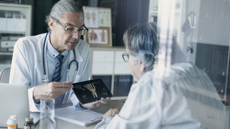 A woman discusses the diagnosis of osteoporosis with her doctor.