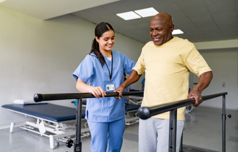Physical therapist helps older adult at senior rehabilitation center